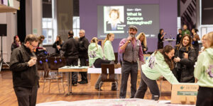 People stood in the Refectory in front of presentation