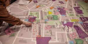 Student placing stickers on campus map