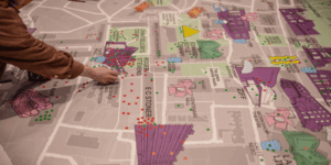 Student placing sticker on campus map